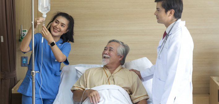 Doctor and patient healthcare concept. doctor and nurse, patient with iv drip in bed in hospital. Doctor and patient healthcare concept. doctor and nurse, patient with iv drip in bed in hospital. IV Drip Stock Photo Description  Doctor and patient healthc