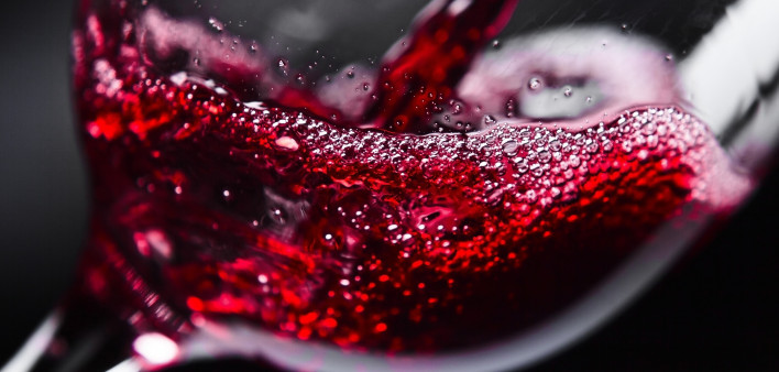 red wine pouring into glass