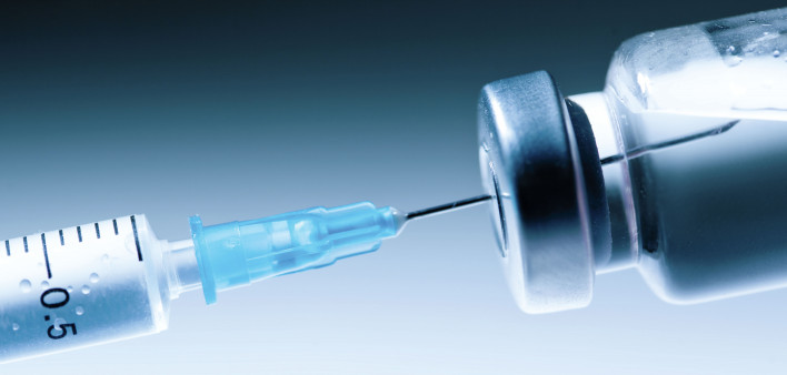 Medical syringe with a needle and a bollte with vaccine