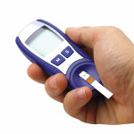 hand holding glucose monitor