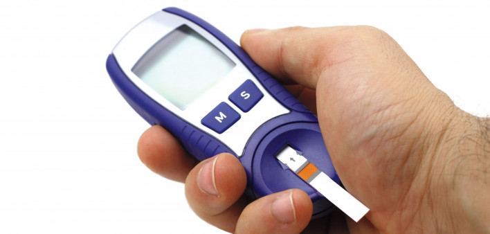 hand holding glucose monitor