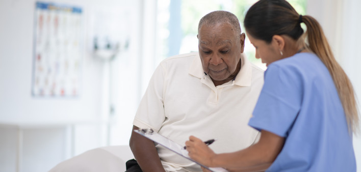 An Elderly Gentleman in His Doctors Office Receiving a Check-Up