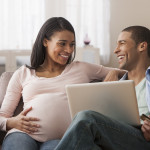 pregant woman smilng couple