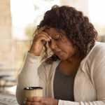 African American middle age woman looking sad.