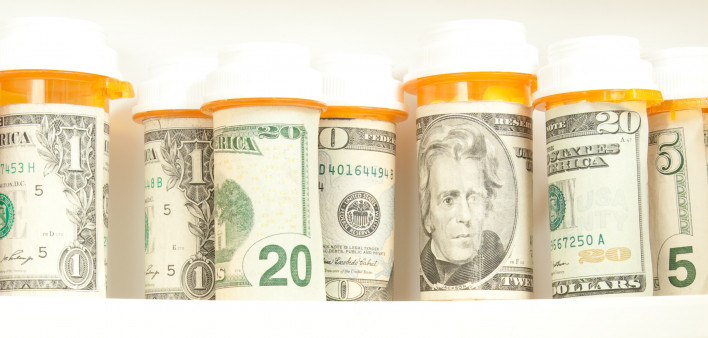 pill bottles with money as labels cost of healthcare