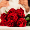 Valentine's Romantic Date. Red Roses Lying On Table, Unrecognizable Spouses Drinking Wine In