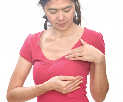 woman holding breast exam