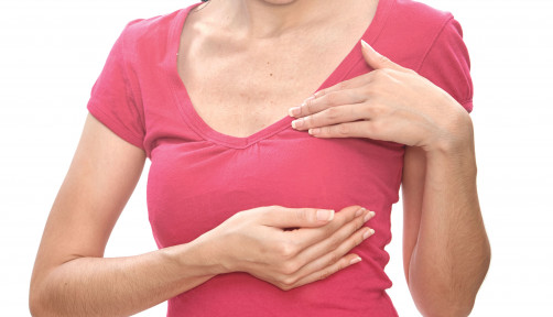 woman holding breast exam