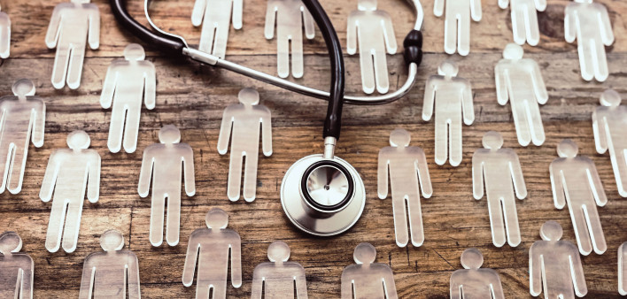 photo illustration figures and stethoscope on wood