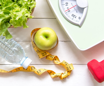 Green apple and Weight scale,measure tape with fresh vegetable, clean water and sport equipment for women diet slimming