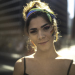 Transgender woman looking at camera during pride parade
