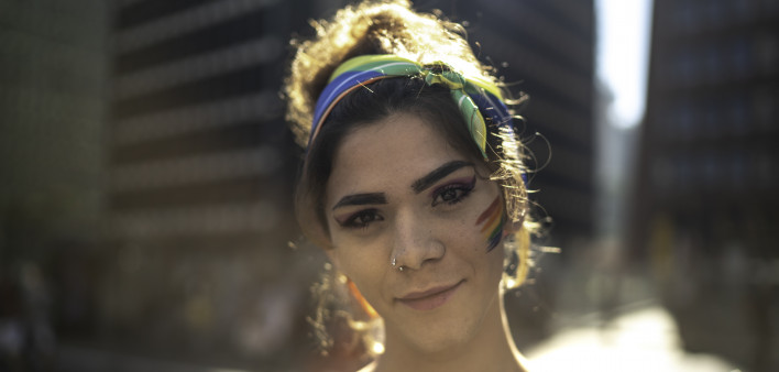 Transgender woman looking at camera during pride parade