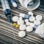 syringe and pills