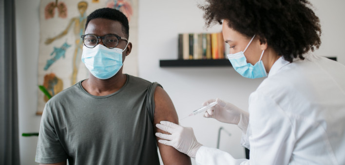 black patient man getting vaccine face mask covid coronavirus