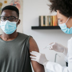 black patient man getting vaccine face mask covid coronavirus