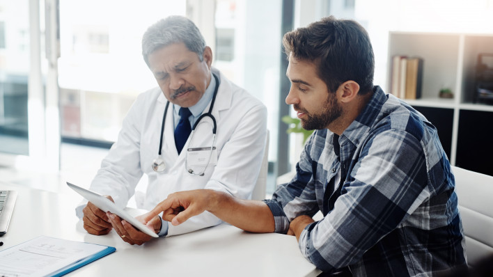 Cropped shot of a mature male doctor and patient having a discussion in the doctor's office before a checkup