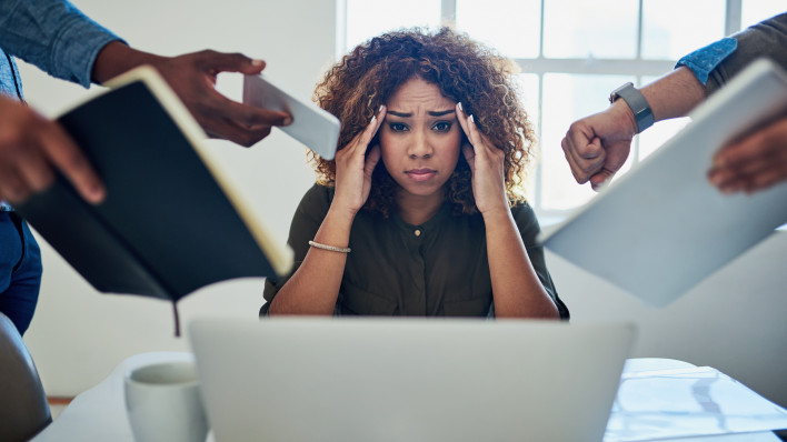 Shot of a stressed out young woman working in a demanding career