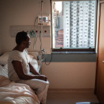 black patient in the hospital sitting in bed