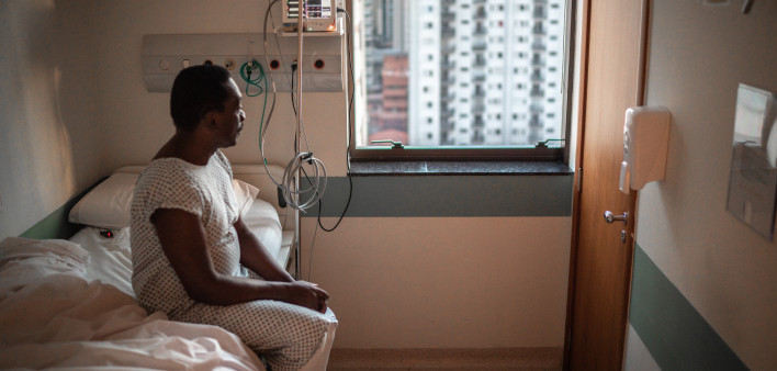 black patient in the hospital sitting in bed
