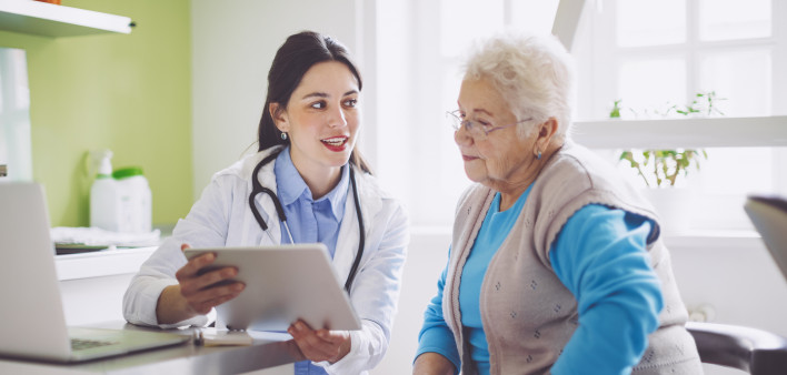 doctor showing patient ipad tablet