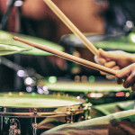 hands playing drums drum sticks