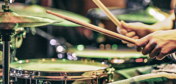 hands playing drums drum sticks