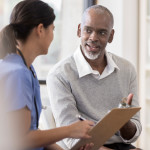 Senior man discusses diagnosis with doctor
