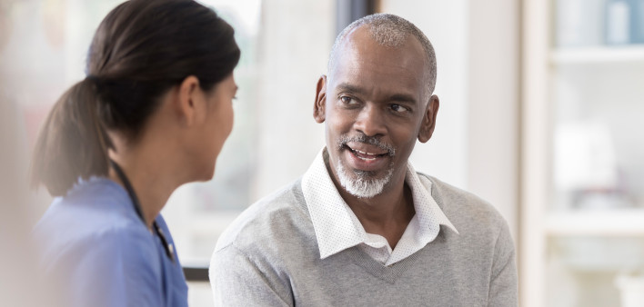 Senior man discusses diagnosis with doctor
