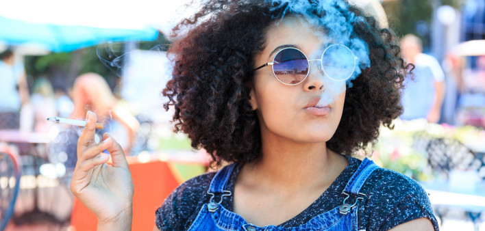 African American woman smoking in cafeteria