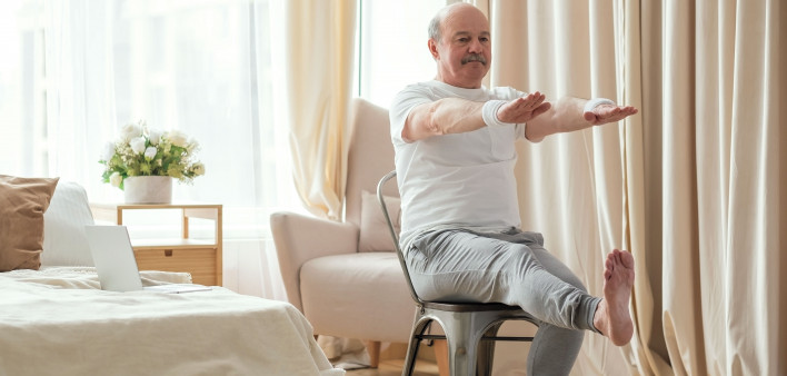 man exercising sitting in a chair