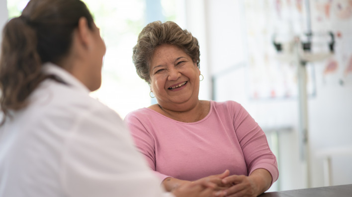 Older Woman talking with the Doctor laughing