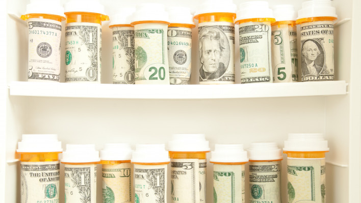 pill bottles with money as labels cost of healthcare