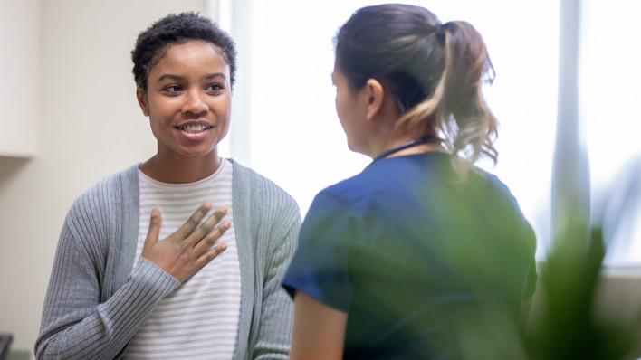 Nurse explaining good news to female patient