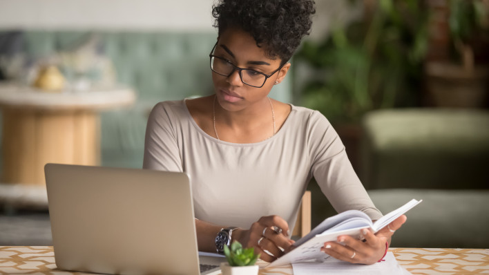 woman sitting at table with labtop
