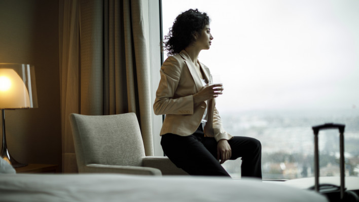 Businesswoman relaxing in a hotel room