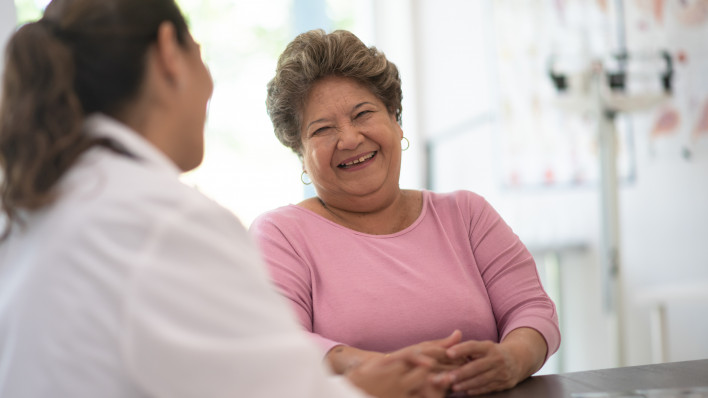 Older Woman talking with the Doctor laughing