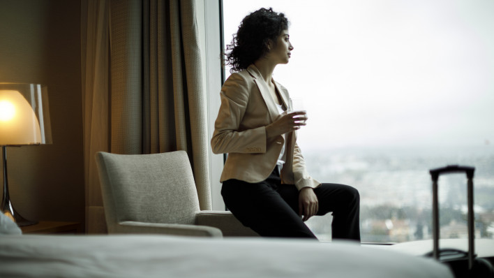 Businesswoman relaxing in a hotel room