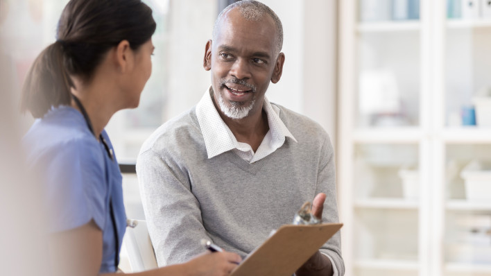 Senior man discusses diagnosis with doctor