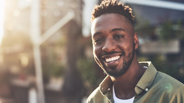 Cropped shot of a handsome young man chilling at an outdoors coffee shop happy smiling man