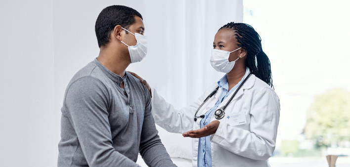 black doctor taklking to latin patient