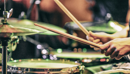 hands playing drums drum sticks