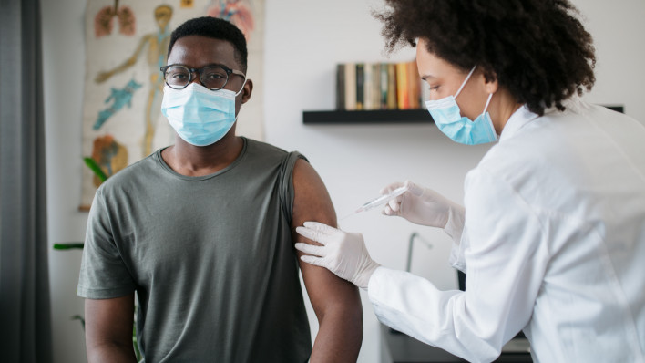 black patient man getting vaccine face mask covid coronavirus