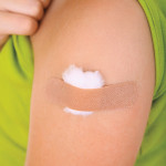 arm with band aid after vaccine