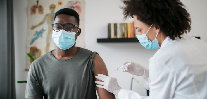 black patient man getting vaccine face mask covid coronavirus