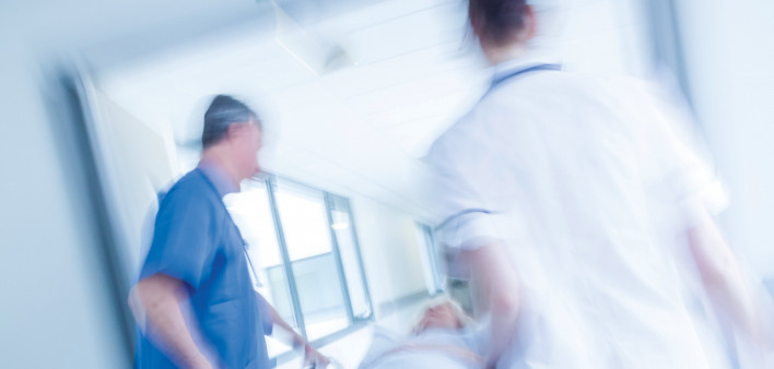 patient being wheeled on gurney in hospital
