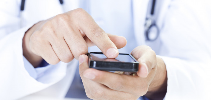  a doctor touching a smart phone