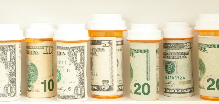 pill bottles with money as labels cost of healthcare