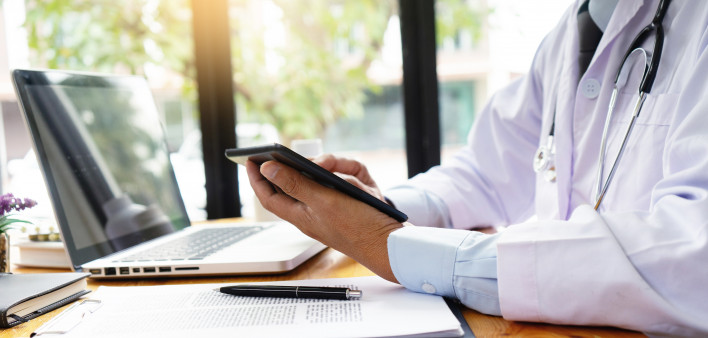 professional doctor use computer and tablet