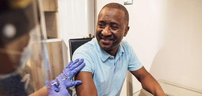 black man getting coronavirus vaccine