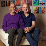 Vishwas and his husband, Joe, in front of Vishwas’s art in 2021